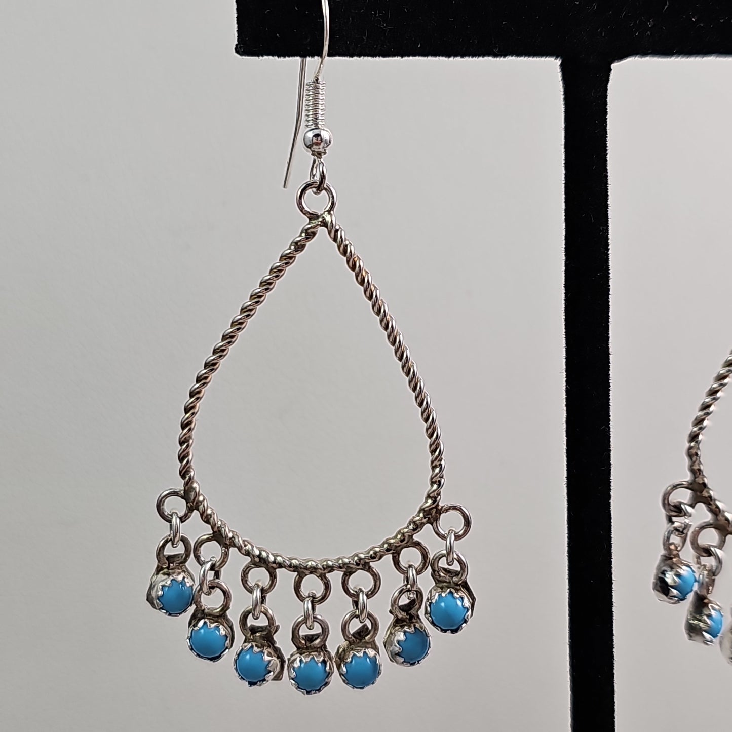 Snake eye charmed teardrop earrings