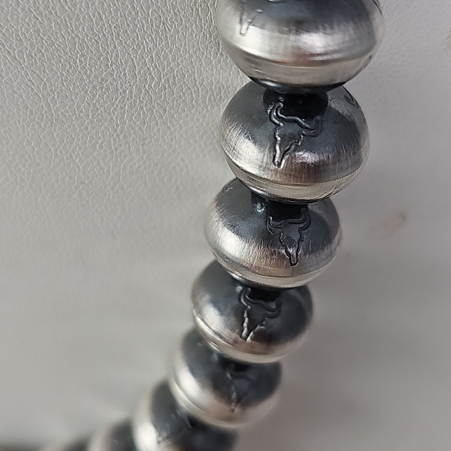 Steer head stamped Navajo pearls