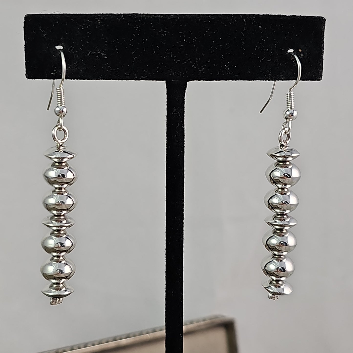 Navajo pearl earrings with saucer bead accents.