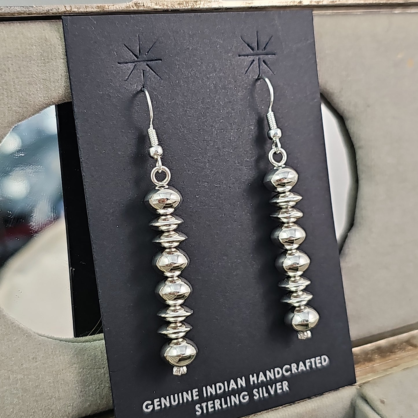 Navajo pearl earrings with saucer bead accents.
