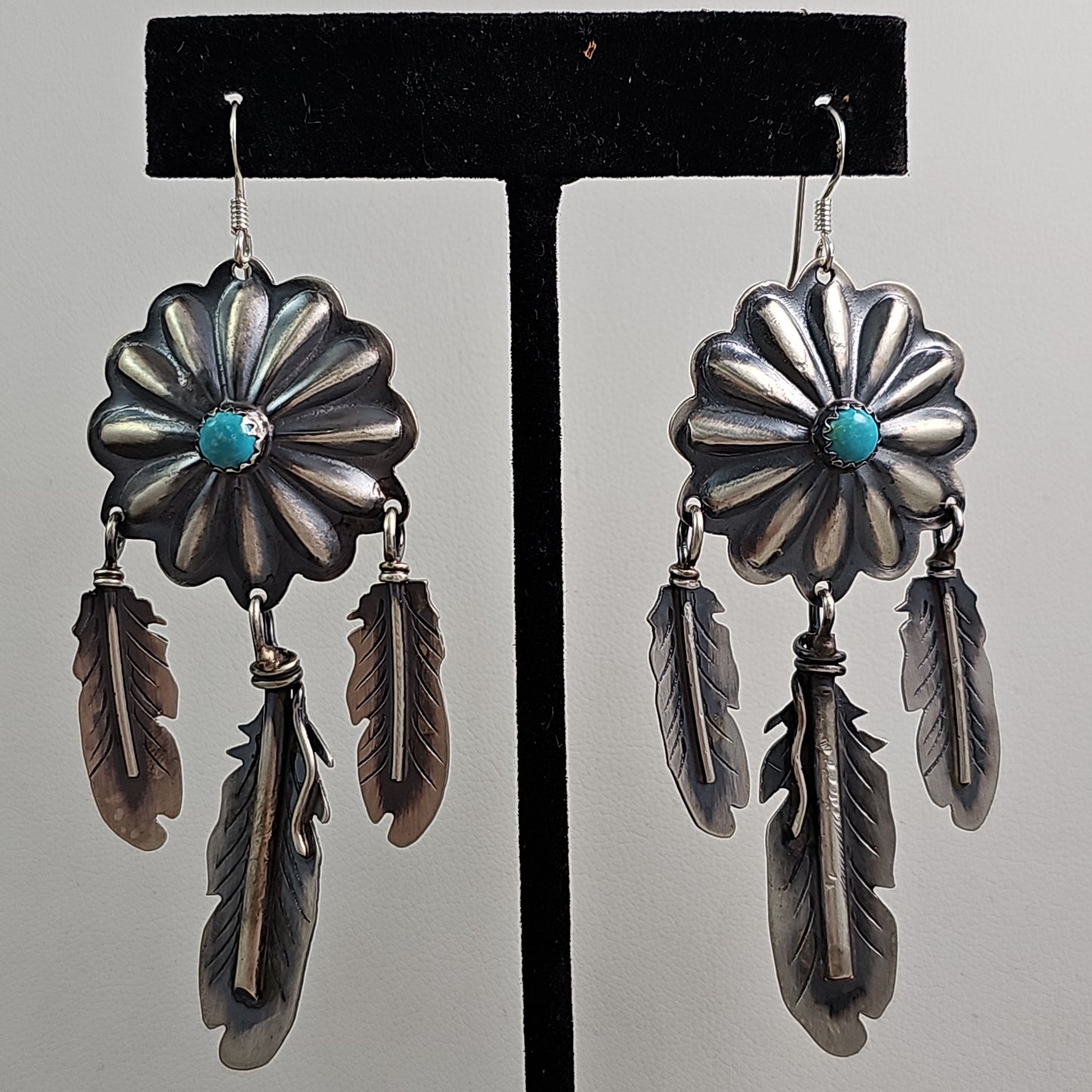 Concho feather chandelier earrings.